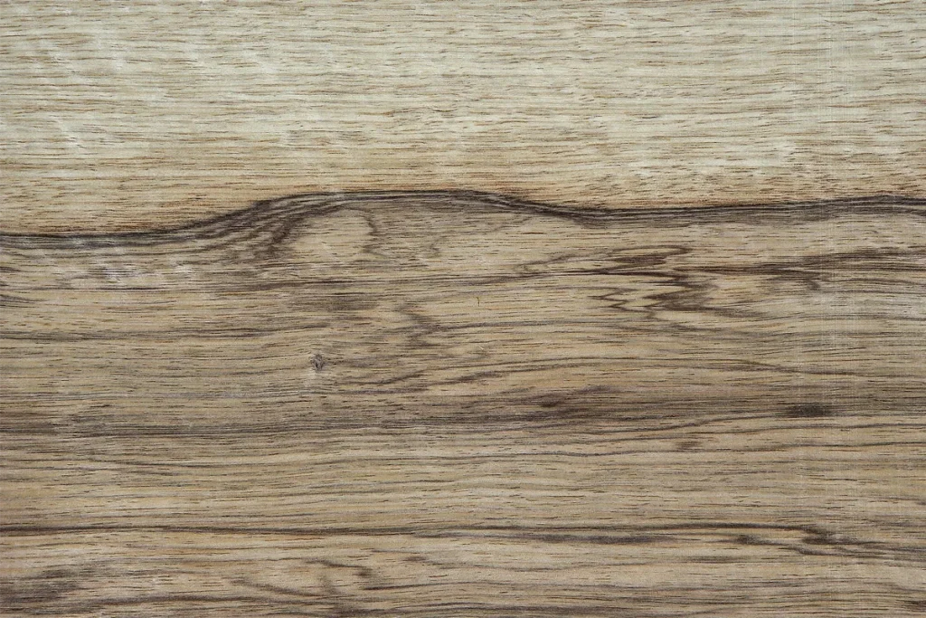 Black limba wood veneer quarter cut with strong contrast between light areas and dark streaks