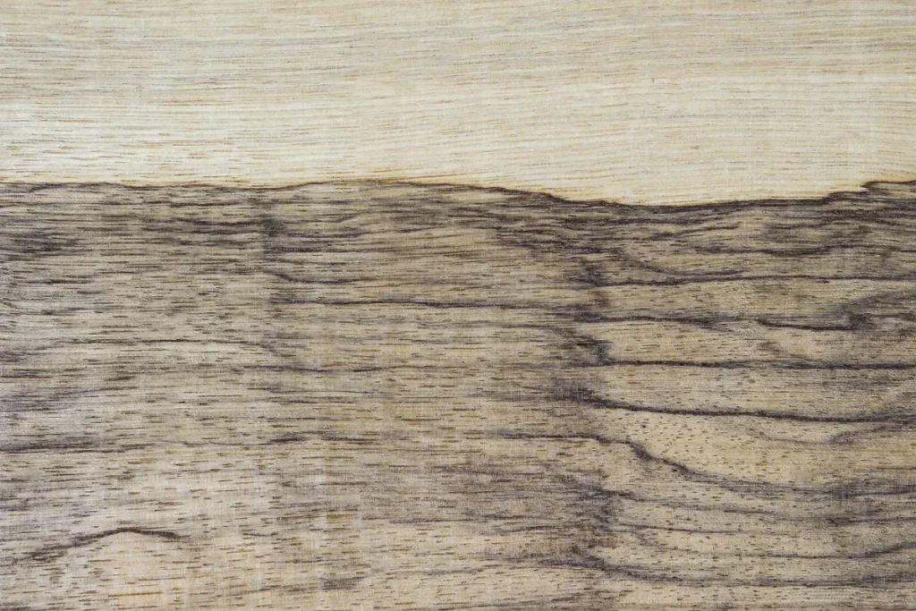 Black limba wood veneer quarter cut with dark linear grain and expressive texture