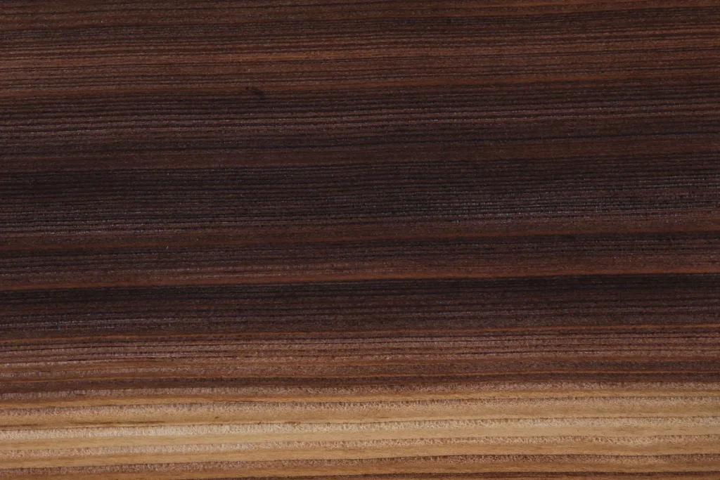 Fumed larch veneer quarter cut with alternating very dark and light areas and natural texture