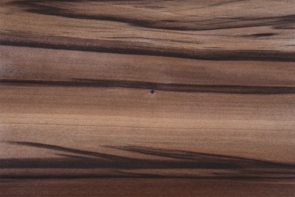 Quarter cut fumed red gum veneer with linear grain and enhanced contrast between medium brown and dark streaks