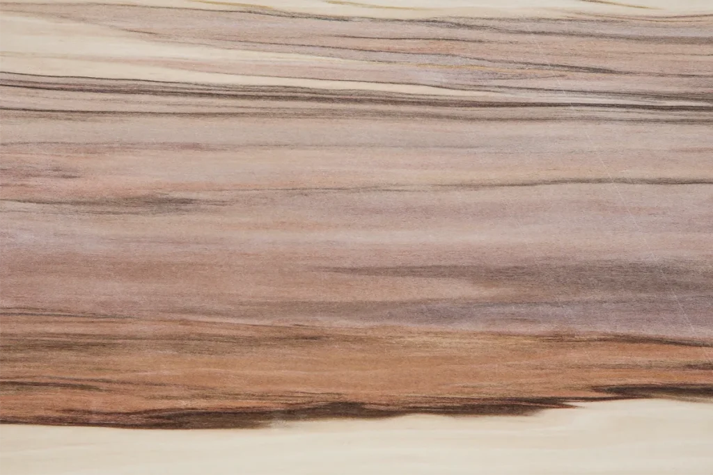 Quarter cut red gum veneer with irregular lines, pinkish tones and warm brown contrasts
