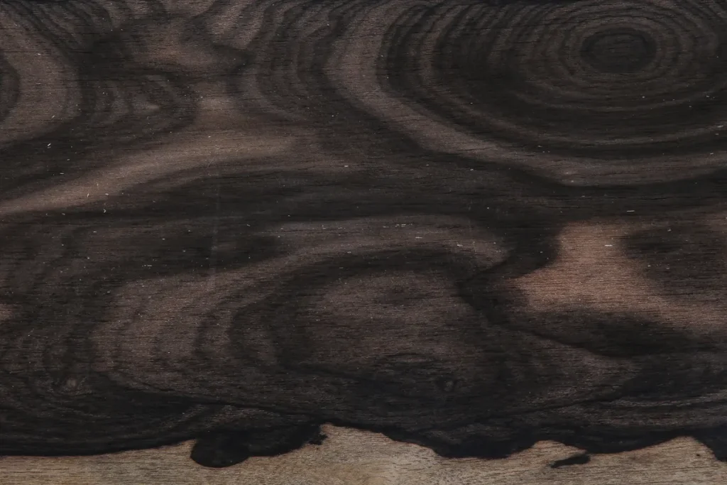 Flat cut Ziricote wood veneer with dark grain and circular contrasting patterns